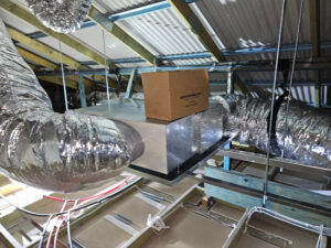 Reverse cycle air conditioning unit installed in roof space